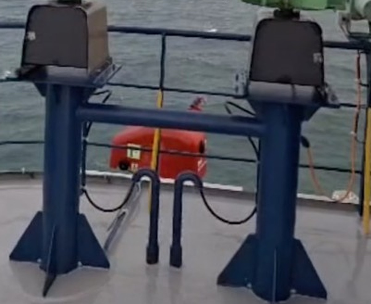 Close view of two Wekraft Atlas turbines on gusseted steel pedestals bolted to a ship deck, with cable glands and drip loops running below